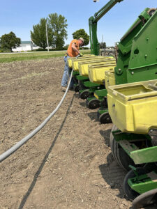 Farmer filling the planter with seed.