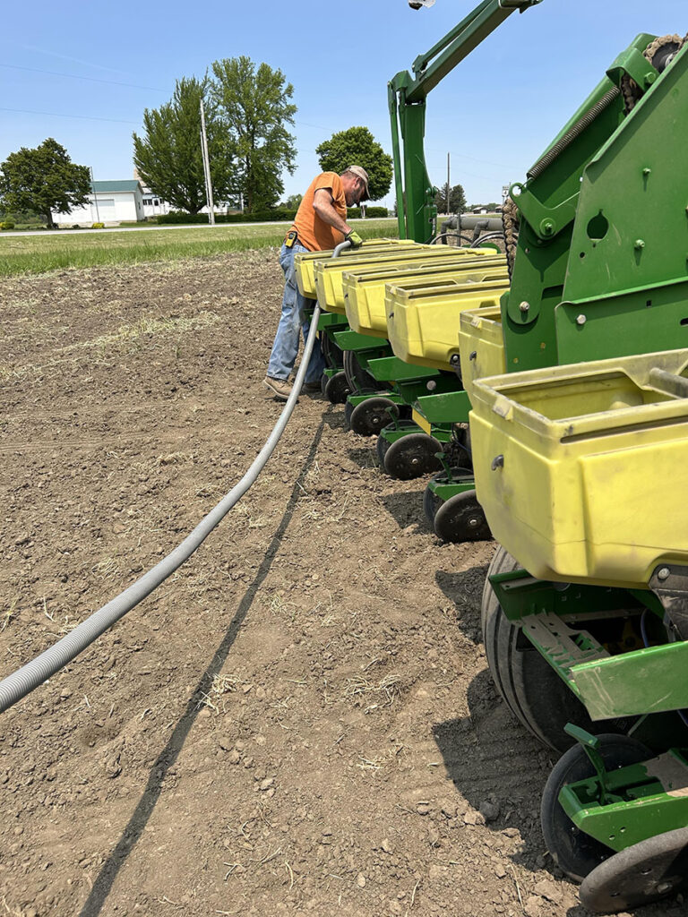 Farmer filling the planter with seed.